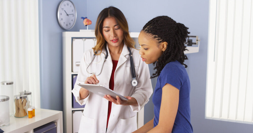 doctor talking to patient and showing her test results