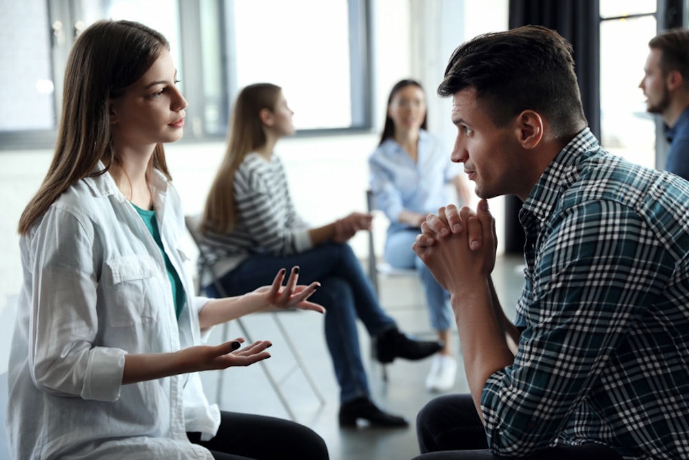 man and woman apart in group therapy