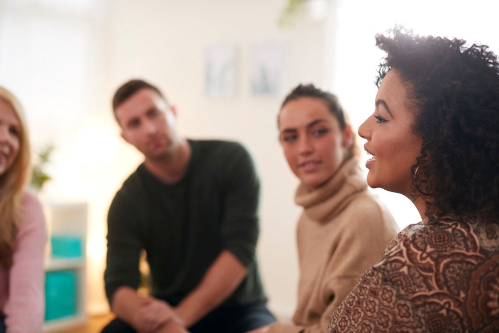 woman addressing a group of adults