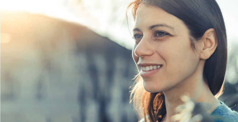 close up of woman smiling and looking into the distance