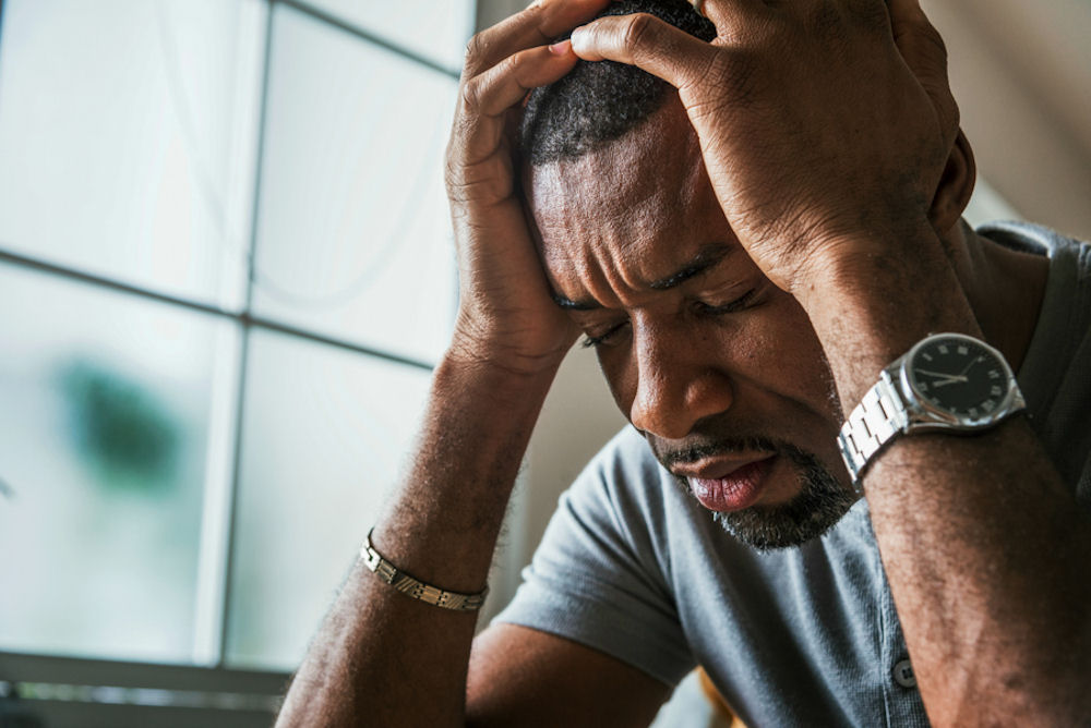 depressed man with his head in his hands