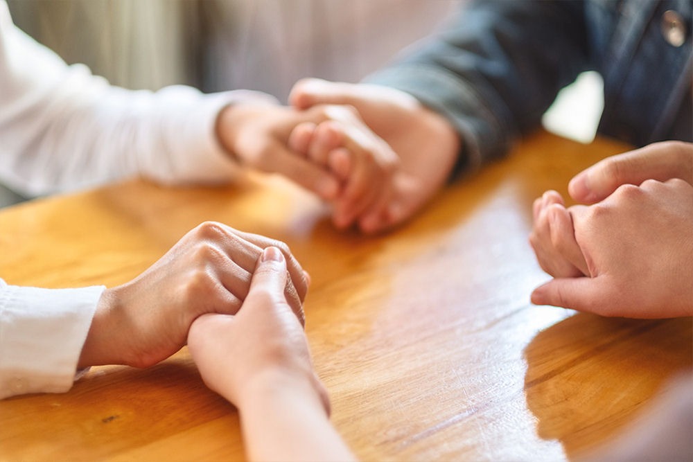 group holding hands in therapy